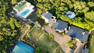 an aerial view of a house with a swimming pool at Cabañas La casita de las sierras in Barrio Parque El Corcovado