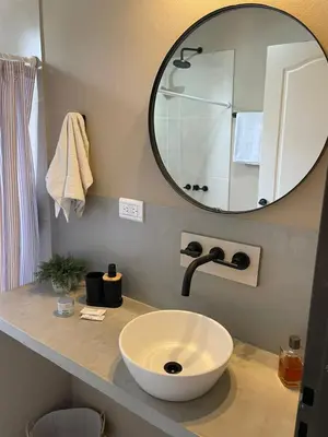 a bathroom with a white sink and a mirror at Cabañas Arenas del Panaholma in Villa Cura Brochero