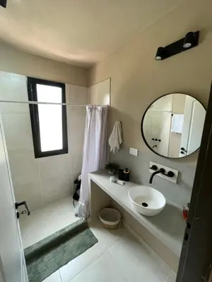 a bathroom with a sink and a mirror at Cabañas Arenas del Panaholma in Villa Cura Brochero