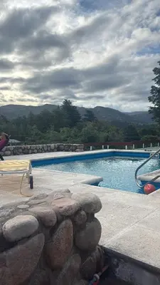 a swimming pool with a rock wall around it at La Matera, San Clemente, Córdoba in San Clemente