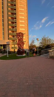 a person standing in front of a tall building at Departamento en complejo residencial entero en Córdoba, Argentina in Cordoba