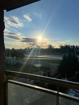 a view of the sun setting over a tennis court at Departamento en complejo residencial entero en Córdoba, Argentina in Cordoba