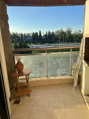 a balcony with a table and a vase on it at Departamento en complejo residencial entero en Córdoba, Argentina in Cordoba