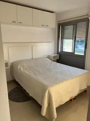 a bedroom with a bed and a window at Departamento en complejo residencial entero en Córdoba, Argentina in Cordoba