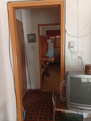 a room with a television and a hallway at Departamento Temporario y Complejo Habitacional in Villa Carlos Paz