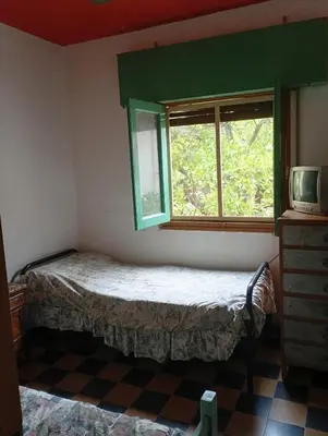 a small bedroom with a bed and a window at Departamento Temporario y Complejo Habitacional in Villa Carlos Paz