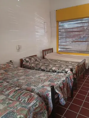 two beds sitting next to each other in a room at Departamento Temporario y Complejo Habitacional in Villa Carlos Paz