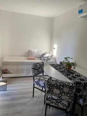 a room with a bed and a table and chairs at EcoBox in Despeñaderos