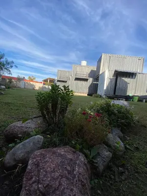a large white building with some rocks in a field at EcoBox in Despeñaderos