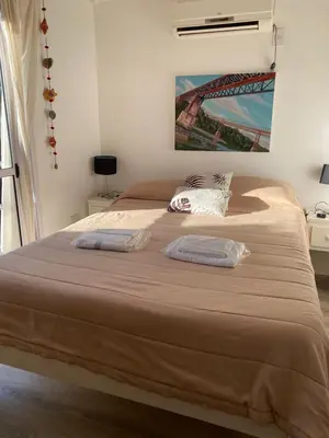 a bedroom with a large bed with two pillows on it at EcoBox in Despeñaderos