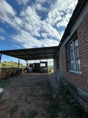 a building with awning next to a brick building at Casa Estancia in Villa Carlos Paz