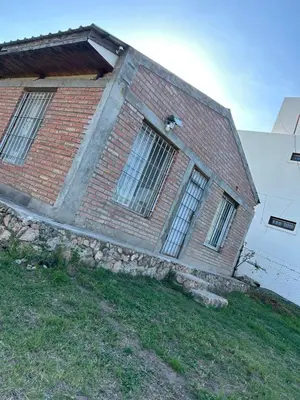 a brick building with windows on the side of it at Casa Estancia in Villa Carlos Paz