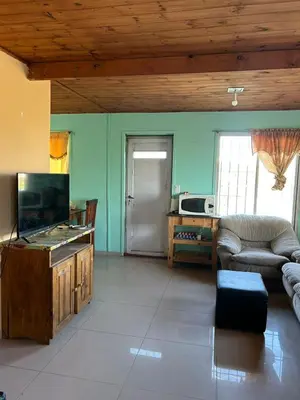 a living room with a couch and a tv at Casa Estancia in Villa Carlos Paz