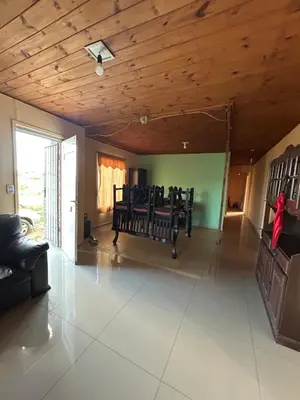 a living room with a wooden ceiling and chairs at Casa Estancia in Villa Carlos Paz