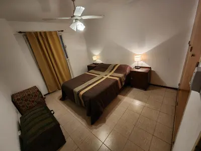 a bedroom with a bed and a ceiling fan at Depto Victoria in Cordoba