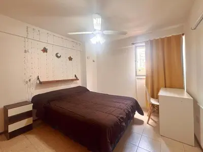 a bedroom with a bed and a ceiling fan at Depto Victoria in Cordoba