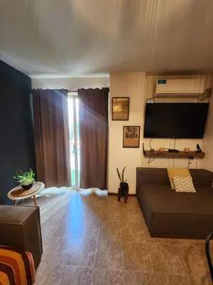 a living room with a couch and a flat screen tv at Depto Victoria in Cordoba