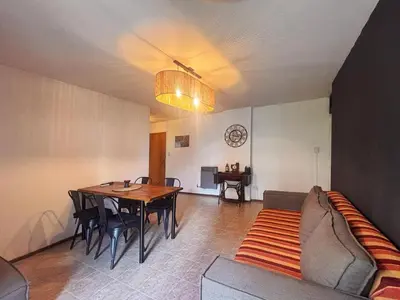 a living room with a table and a couch at Depto Victoria in Cordoba