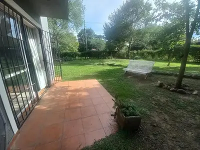 a patio with a bench in a yard at Tantanakuy 4 in Villa General Belgrano