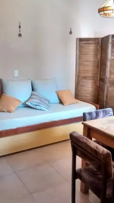 a bed in a room with a table and a chair at Casita del Lago in Villa Carlos Paz
