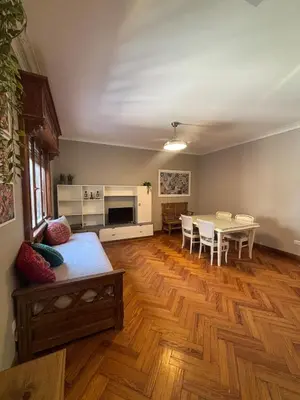 a living room with a table and a dining room at Apartment in the historic center in Cordoba
