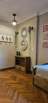 a bedroom with a bed and a wooden floor at Apartment in the historic center in Cordoba