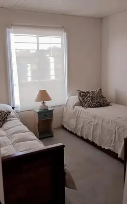 a bedroom with two beds and a window at Casa Pileta Playa Tanti - Cabalango in Tanti