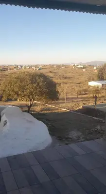 a mound of snow next to a field with a tree at Casa Pileta Playa Tanti - Cabalango in Tanti