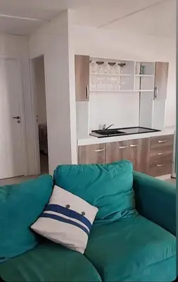 a green couch with a pillow in a kitchen at Casa Pileta Playa Tanti - Cabalango in Tanti
