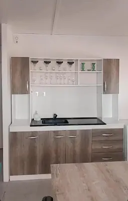 a kitchen with a sink and wooden cabinets at Casa Pileta Playa Tanti - Cabalango in Tanti