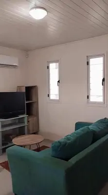 a living room with a couch and a table at Casa Pileta Playa Tanti - Cabalango in Tanti
