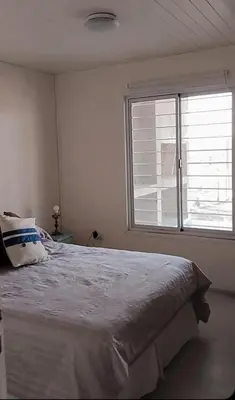 a bedroom with a large bed and a window at Casa Pileta Playa Tanti - Cabalango in Tanti