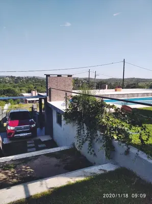 a car parked in a parking lot next to a building at paraíso lomas in San Antonio de Arredondo