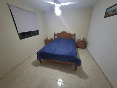 a bedroom with a bed and a flat screen tv at paraíso lomas in San Antonio de Arredondo