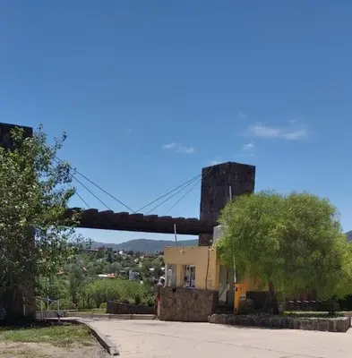 a bridge over a street with a house and a building at paraíso lomas in San Antonio de Arredondo