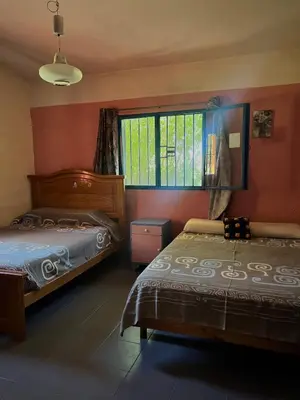 a bedroom with two beds and a window at Mar y Mar Naturaleza y comodidad in La Estancia