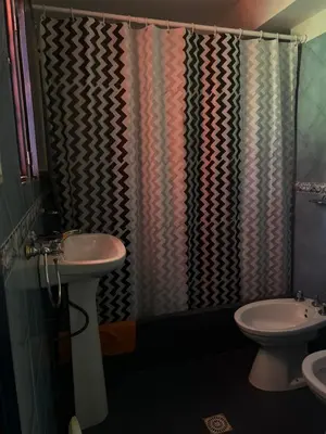 a bathroom with a sink and a shower curtain at Mar y Mar Naturaleza y comodidad in La Estancia