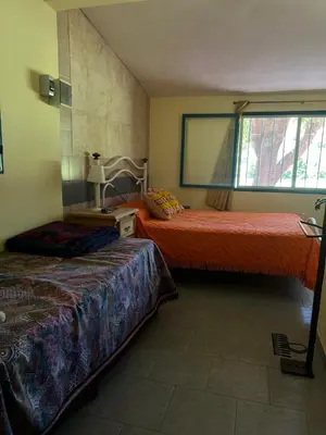 a bedroom with two beds and a window at Mar y Mar Naturaleza y comodidad in La Estancia
