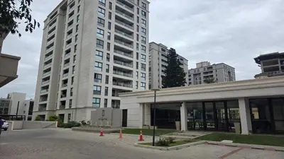 a large white building in a city with tall buildings at Opera Park en Barrio Las Rosas in Cordoba