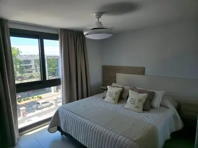 a bedroom with a bed and a large window at Opera Park en Barrio Las Rosas in Cordoba