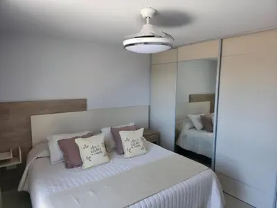 a bedroom with a large white bed with pillows at Opera Park en Barrio Las Rosas in Cordoba