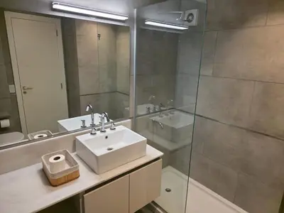 a bathroom with a sink and a glass shower at Opera Park en Barrio Las Rosas in Cordoba