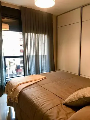 a bedroom with a large bed with a large window at NUEVA CORDOBA, Zona PLAZA ESPAÑA PARQUE SARMIENTO in Cordoba