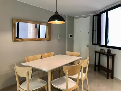a dining room with a white table and chairs at NUEVA CORDOBA, Zona PLAZA ESPAÑA PARQUE SARMIENTO in Cordoba