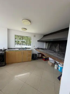 a large kitchen with a sink and a window at Depto Carillo 4p in Villa Carlos Paz