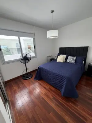 a bedroom with a bed and a fan at Depto Carillo 4p in Villa Carlos Paz