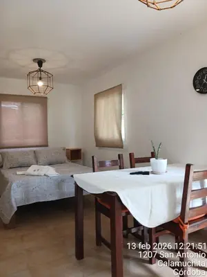 a living room with a table and a couch at Sami LLankay II in Villa Ciudad Parque