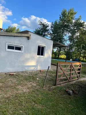a small house with a fence in front of it at Sami LLankay II in Villa Ciudad Parque