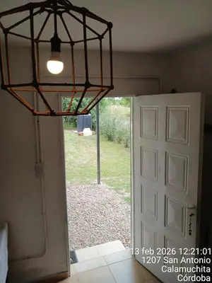 a room with a door and a chandelier at Sami LLankay II in Villa Ciudad Parque