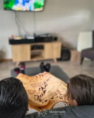 a person laying on a couch with a pillow at Mutterstern Chalet Boutique in Villa General Belgrano